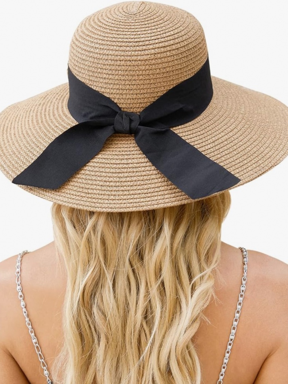 Classic straw sun hat. Wide brim with a tied black ribbon bow. Lightweight and c